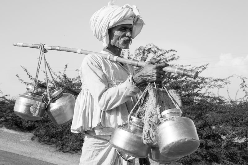 Men and Drinking Water Procurement - shepherd proceeding to fill water for his long day in the pastures in Kutch district, Gujarat